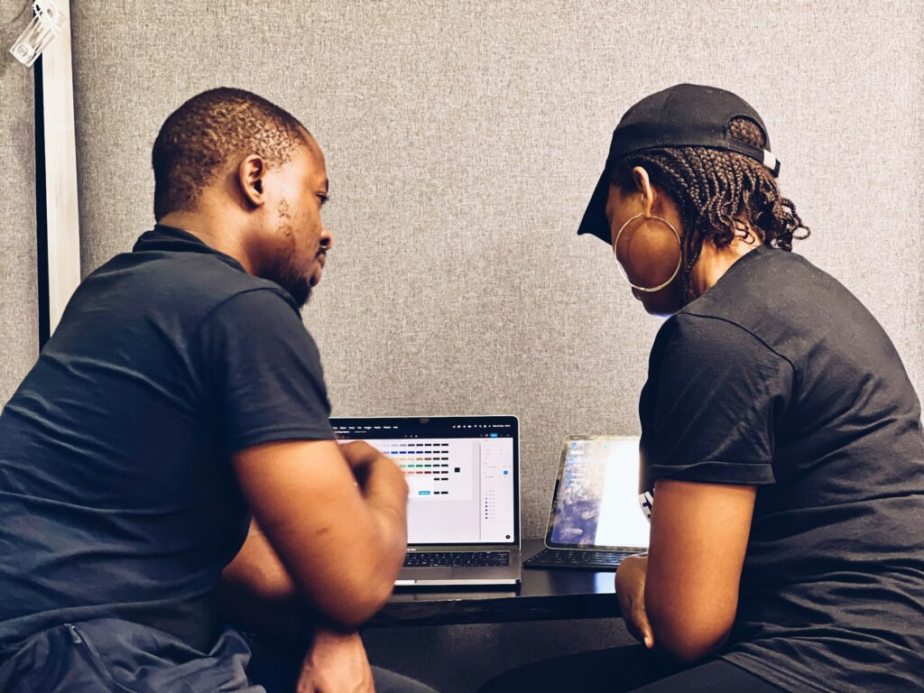 Two founders collaborating on a business plan at a laptop