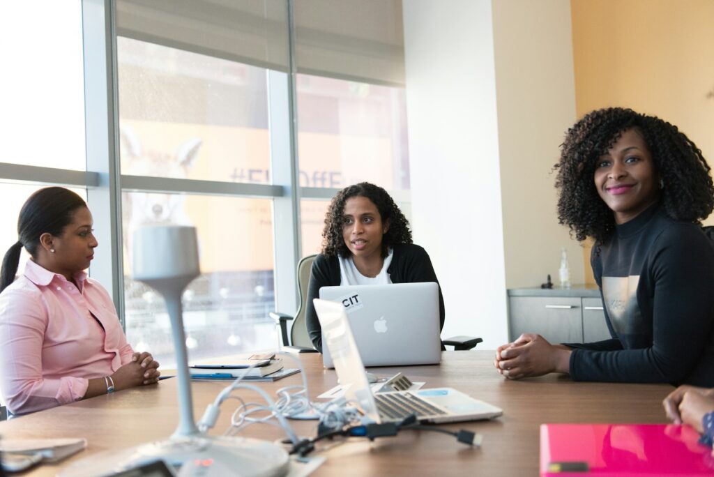 Professionals working on laptops in a bright coworking space